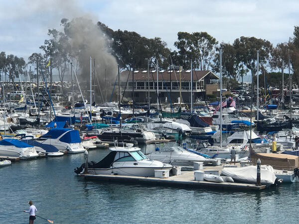 Firefighters work the scene where a boat exploded and caught...