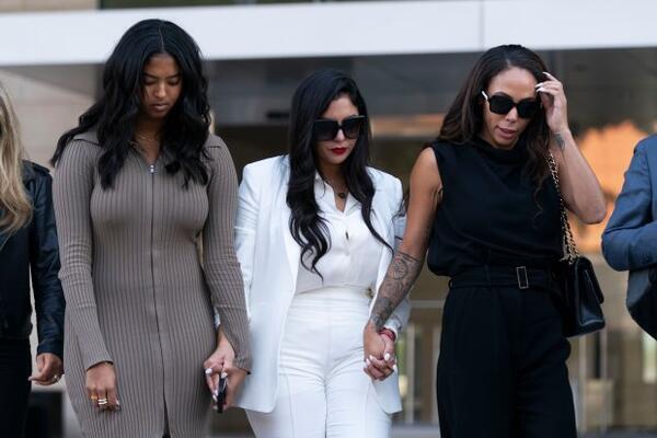 Vanessa Bryant, center, Kobe Bryant's widow, leaves a federal courthouse with her daughter, Natalia, left, and soccer player Sydney Leroux in Los Angeles, Wednesday, Aug. 24, 2022. A federal jury has found that Los Angeles County must pay Bryant's widow $16 million over photos of the NBA star's body at the site of the 2020 helicopter crash that killed him. On Aug. 30, the LA County Board of Supervisors asked for a report on how to implement policies on fire department and sheriff deputies taking photos at crash sites of human remains. (AP Photo/Jae C. Hong)