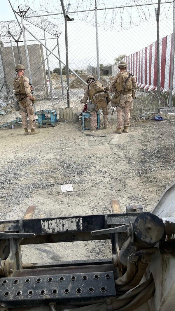 Marines lay security wire at the airport in Kabul in...