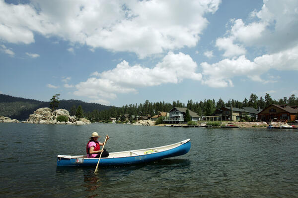 A woman paddles along the shore in Boulder Bay part...
