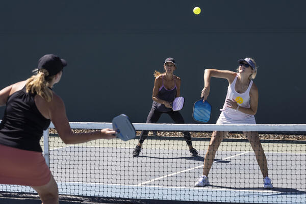 Kimberly Koford, right, plays pickleball in Seal Beach on Thursday,...