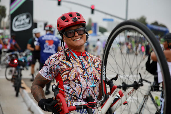 Aaron Hu of Long Beach raises his wheel on Sunday,...