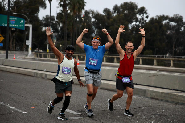 Happy runners cross the Queensway Bridge early Sunday, Oct. 9,...