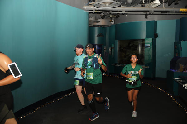Participants run through the aquarium on Saturday, Oct. 8, 2022,...