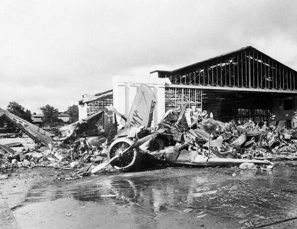 In this photo provided by the Department of Defense, U.S. aircraft destroyed as a result of the Japanese bombing on Pearl Harbor is shown, Dec. 7, 1941. Heap of demolished hanger in background Army amphibian in foreground. (AP Photo/DOD)