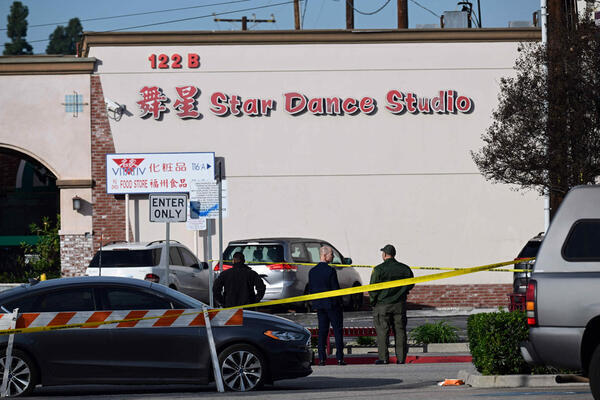 Investigators work at the scene of a mass shooting in...