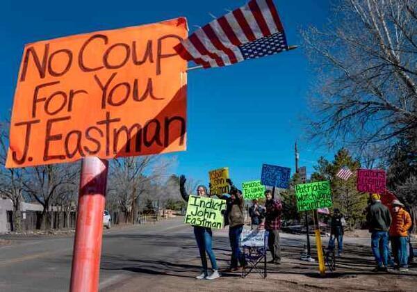 From left, Carol Norris, Jerry Williams, Brent Lambert, Dave Wheelock and other residents of Santa Fe protest along side Bishops Lodge Road,  in Santa Fe, Thursday,  February 2, 2023. The are protesting against thier neighbor John Eastman who was President Donald Trump's attorney. (Eddie Moore/Albuquerque Journal)