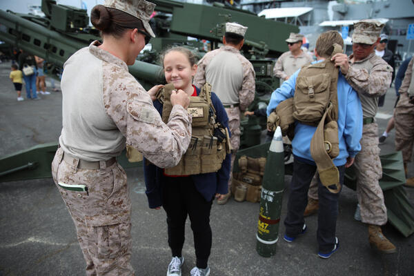 A Marine helps Makynzie Williams, 9, of San Bernardino put...