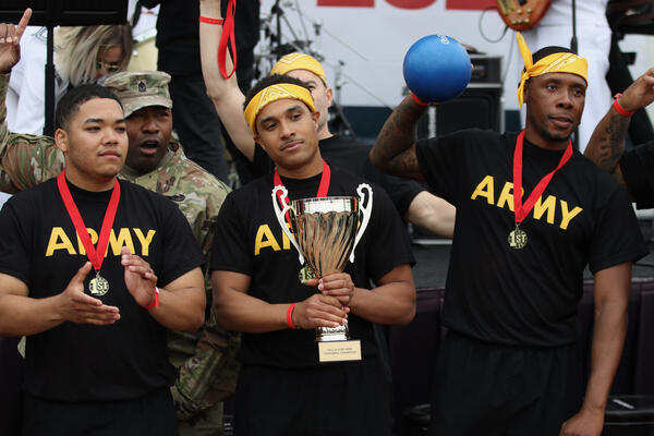 Team Army displays their championship trophy after winning the military...