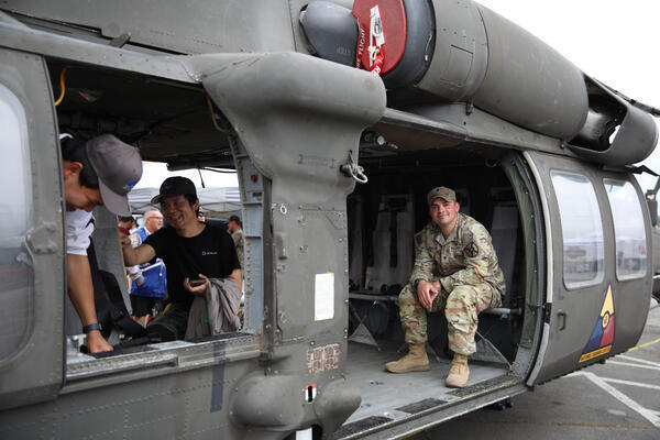 Visitors explore the inside of a UH-60L Blackhawk as Army...
