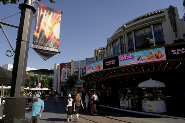 Advertisements for the films “Oppenheimer” and “Barbie” appear at AMC...